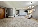 Bright living area with plush carpet, cozy chairs, and a ceiling fan at 741 Springmill Dr, Mooresville, IN 46158