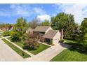 Aerial view of a single-Gathering home with a long driveway and meticulously maintained landscaping at 742 Marana Dr, Carmel, IN 46032