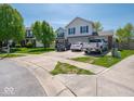 A two-story home with a driveway, landscaping, and exterior features at 7611 Penguin Cir, Indianapolis, IN 46239