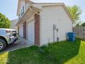 A three-car garage with brick accents, and manicured lawn at 7611 Penguin Cir, Indianapolis, IN 46239