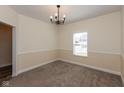 Bright, carpeted dining room with neutral walls and a window, perfect for Gathering meals at 7643 Belmac Ln, Camby, IN 46113