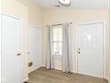 Bright entryway featuring wood-look floors, neutral walls, and two convenient interior doors at 8141 Maple Stream Ln, Indianapolis, IN 46217