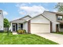 Welcoming home with a two-car garage and a well-maintained lawn, ideal for Gathering living at 8141 Maple Stream Ln, Indianapolis, IN 46217