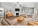 Bright living room with vaulted ceilings, a fireplace, neutral decor, and a cozy seating area at 8146 Whitaker Valley Blvd, Indianapolis, IN 46237