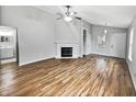 Open living room with hardwood floors, a fireplace, and ample natural light at 8146 Whitaker Valley Blvd, Indianapolis, IN 46237
