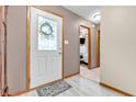 Warm entryway featuring wood-look floors and decorative leaded-glass front door at 8375 Eagles Nest Dr, Avon, IN 46123