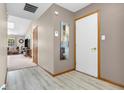 Bright hallway with wood-look flooring, leading to living area and featuring neutral paint at 8375 Eagles Nest Dr, Avon, IN 46123