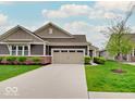 Beautiful home featuring a well-kept lawn and charming curb appeal on a sunny day at 8593 Hudson Way, Brownsburg, IN 46112