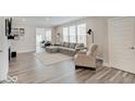 Bright living room with hardwood floors, large sectional sofa, and modern decor at 8593 Hudson Way, Brownsburg, IN 46112
