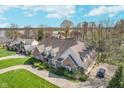 Aerial view of brick home with manicured lawn and circular driveway on a sunny day at 9719 Decatur Dr, Indianapolis, IN 46256