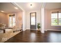 Bright foyer with hardwood floors and a chair for seating near the entrance at 9949 Stable Stone Ter, Fishers, IN 46040