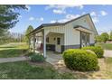 Charming outbuilding with covered porch, decorative doors and lush greenery at 10220 N Serenity Ln, Mooresville, IN 46158
