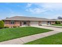 Inviting home exterior with a lush green lawn and convenient driveway at 126 Appian Way, Anderson, IN 46013