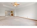 Spacious living room with neutral carpet, ceiling fan, and ample natural light at 126 Appian Way, Anderson, IN 46013