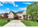 Brick home with a curved drive and mature trees at 13934 Salsbury Creek Dr, Carmel, IN 46032