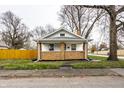 Charming brick home with a cozy front porch at 1451 N Grant Ave, Indianapolis, IN 46201