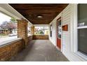 Inviting front porch with brick columns and wood ceiling at 1451 N Grant Ave, Indianapolis, IN 46201