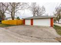 Detached two-car garage with white doors and brick accents, complemented by a paved driveway at 1451 N Grant Ave, Indianapolis, IN 46201