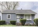 Charming single-story home with gray siding, trimmed hedges, and a well-maintained front yard at 1643 E Tabor St, Indianapolis, IN 46203