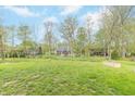 Lush green backyard featuring mature trees, offering shade and privacy for outdoor relaxation at 192 Lynnette Way, Cumberland, IN 46229