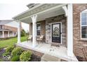 Charming front porch with seating and classic brick columns at 2432 Scarlet Oak Dr, Avon, IN 46123