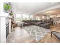 Open living room showcasing a fireplace, large windows, and an open-concept design at 2432 Scarlet Oak Dr, Avon, IN 46123