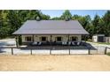 Large barn with metal roof, front porch, and gate to a riding arena at 2450 S Us 421, Zionsville, IN 46077