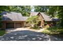 Traditional home with brick facade, two-car garage, and mature landscaping at 2450 S Us 421, Zionsville, IN 46077