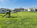 Large backyard with a play set, offering plenty of room for outdoor activities at 261 Punkin Ct, Greenfield, IN 46140