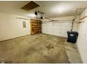 Two-car garage with ample space, storage shelving, and an automatic door opener at 261 Punkin Ct, Greenfield, IN 46140