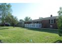 Ranch style house has a well maintained lawn with a white picket fence at 2630 Wedgewood Dr, Columbus, IN 47203