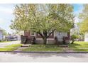 Traditional home with a large tree in the front yard with steps leading to a porch on either side of the home at 300 E 2Nd St, Sheridan, IN 46069