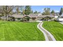 A stunning single-story home featuring a beautifully maintained lawn and a charming walkway, offering curb appeal at 32 W Michigan St, Greenfield, IN 46140