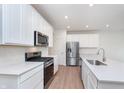 Bright kitchen with white cabinets, stainless steel appliances, and quartz countertops at 3305 Noriker Ln, Zionsville, IN 46077