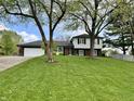 Charming two-story home with a well-manicured lawn and mature trees provides great curb appeal at 337 Leaning Tree Rd, Greenwood, IN 46142