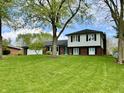Charming two-story home with a well-manicured lawn and mature trees provides great curb appeal at 337 Leaning Tree Rd, Greenwood, IN 46142