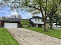 Lovely two-story home featuring a well-kept lawn, a paved driveway and an attached two car garage at 337 Leaning Tree Rd, Greenwood, IN 46142