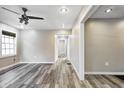 An empty living room with hardwood-style floors, ceiling fan, and neutral paint at 3549 N Sherman Dr, Indianapolis, IN 46218