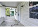 The porch is white and airy, with brick columns and a view of the yard at 3549 N Sherman Dr, Indianapolis, IN 46218