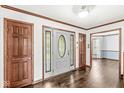 Bright foyer with hardwood floors, a decorative front door, and wood trim at 4152 S Creekside Dr, New Palestine, IN 46163