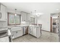 Well-lit kitchen features white cabinets, stone countertops, stainless steel appliances and a view to the breakfast nook at 4152 S Creekside Dr, New Palestine, IN 46163
