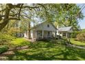 Landscaped front yard with a ramp leading to the covered porch of this charming home at 4710 Hinesley Ave, Indianapolis, IN 46208