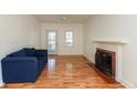 Bright living room features hardwood floors, a fireplace, and a comfortable blue sofa at 4710 Hinesley Ave, Indianapolis, IN 46208