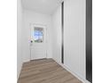 Bright entryway featuring neutral walls, modern flooring, and a glass-paneled front door at 4985 W Burrel Ln, New Palestine, IN 46163
