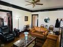 Cozy living room features hardwood floors, a ceiling fan, and neutral paint colors at 551 E 40Th St, Indianapolis, IN 46205