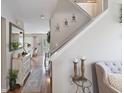 Inviting hallway featuring hardwood floors and staircase leading to the upper level at 5550 Sweet River Dr, Indianapolis, IN 46221