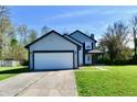 Charming two-story home with gray siding, black trim, and a two-car garage showcasing its curb appeal at 609 Delray Dr, Indianapolis, IN 46241