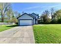 Charming two-story home with gray siding, black trim, and a two-car garage showcasing its curb appeal at 609 Delray Dr, Indianapolis, IN 46241