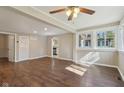 Bright living room featuring wood floors, a ceiling fan, and archway to the adjacent kitchen at 7002 N Ralston Ave, Indianapolis, IN 46220