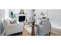 Bright living room featuring modern decor, fresh paint, fireplace, and lots of seating at 717 S A St, Elwood, IN 46036